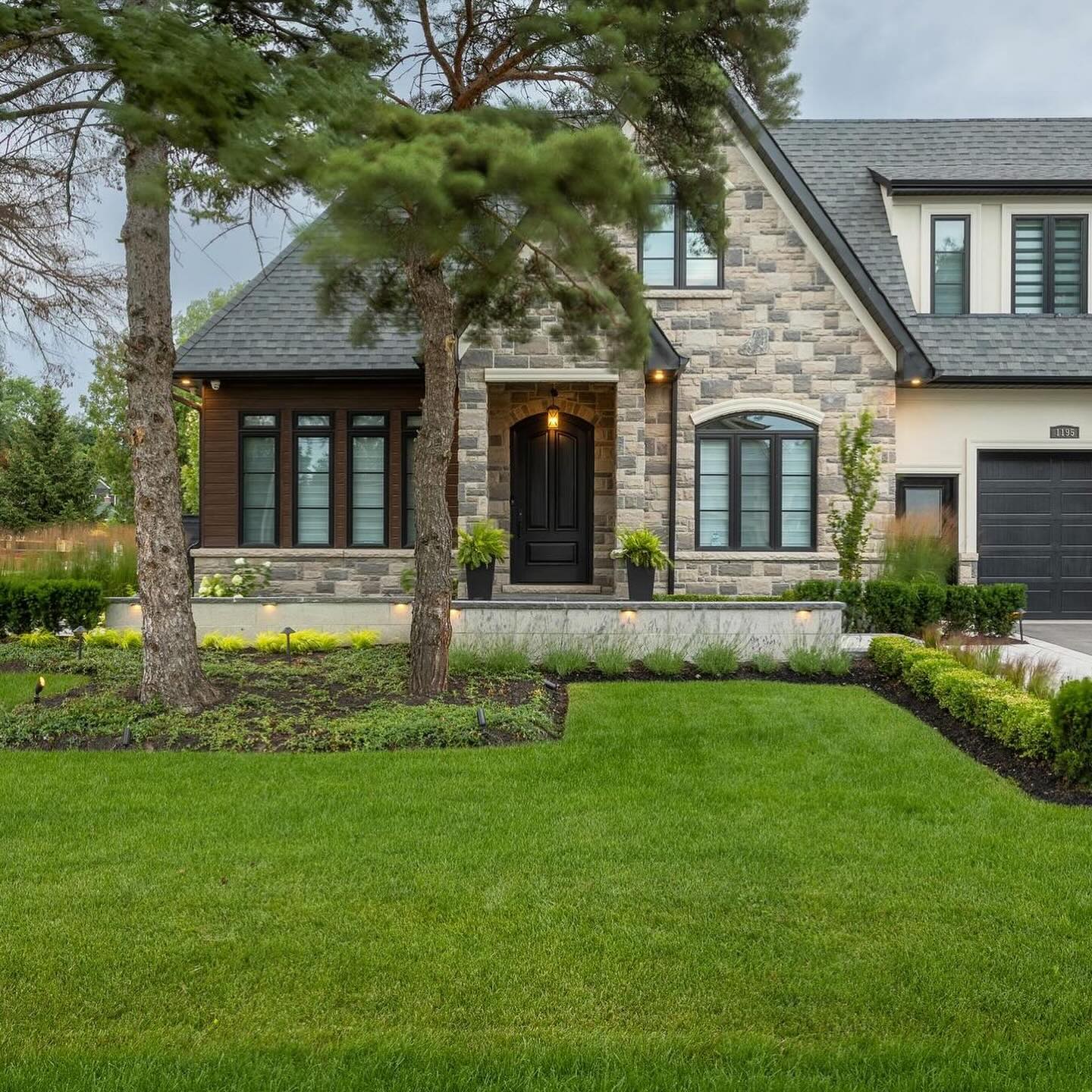 Landscaped lawn and stone facade