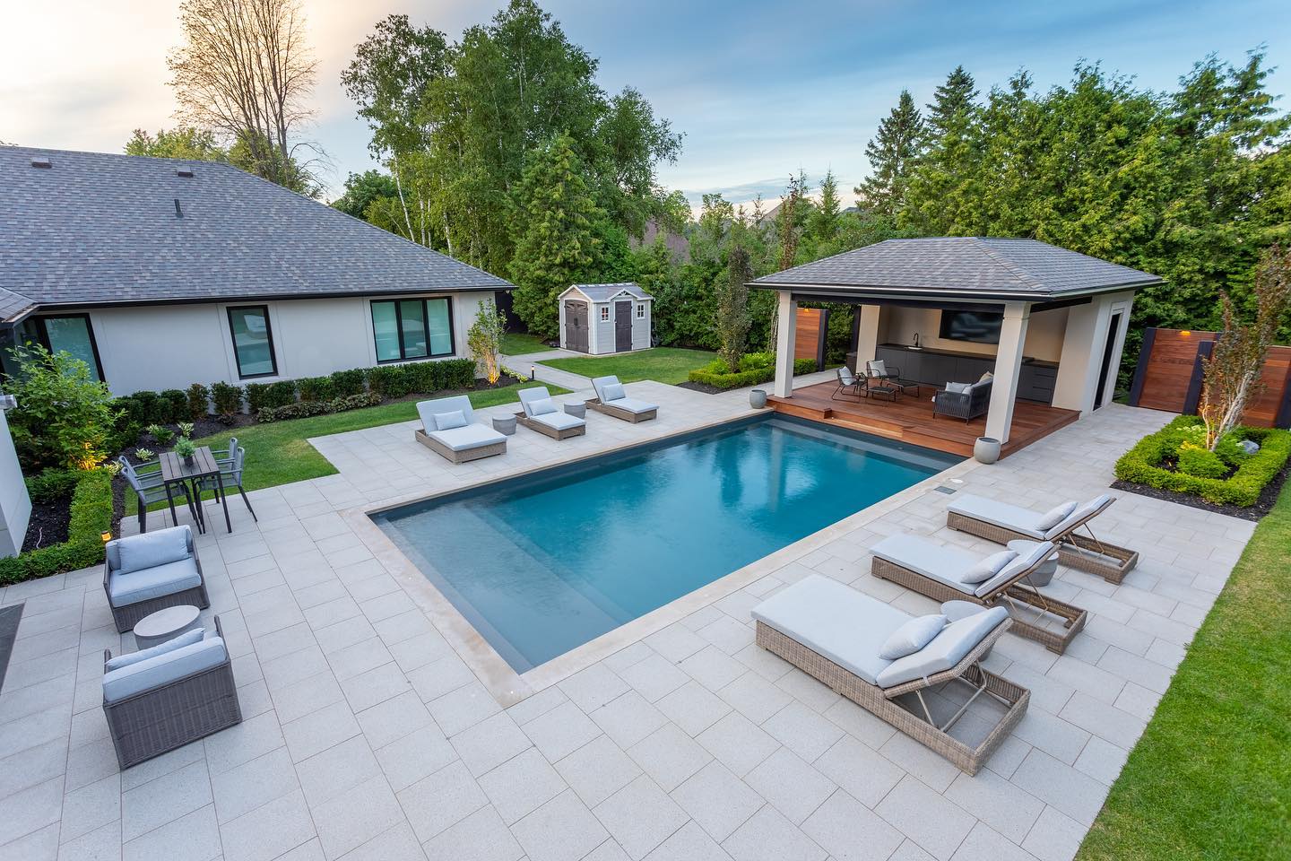 Pool terrace with loungers and a pavilion