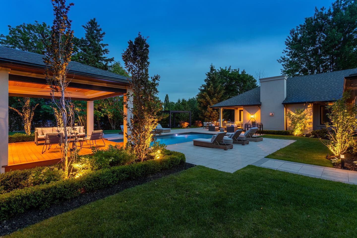 Evening landscape lighting around a pool terrace