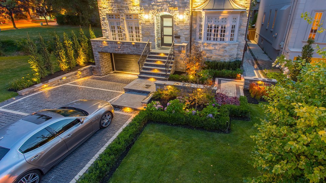 Stone driveway and illuminated front steps