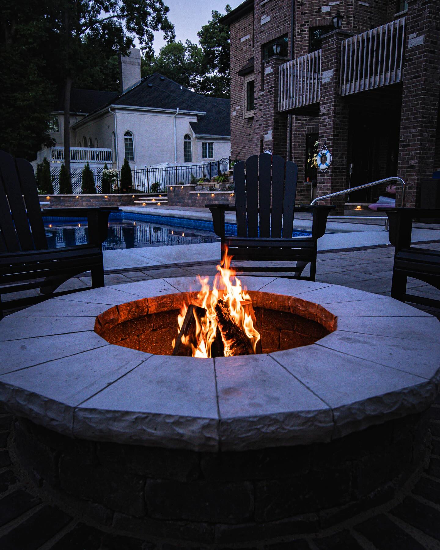 Poolside fire pit at dusk