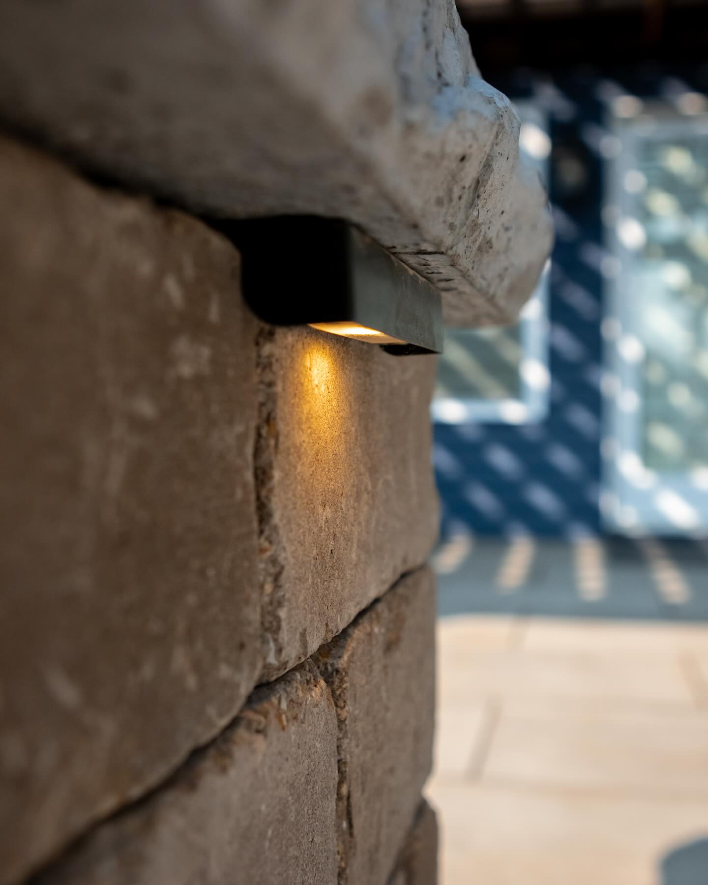 Integrated lighting beneath a stone cap